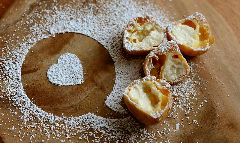 cream-choux-with-heart-shape-design-made-out-of-sugar-on-top-of-a-table