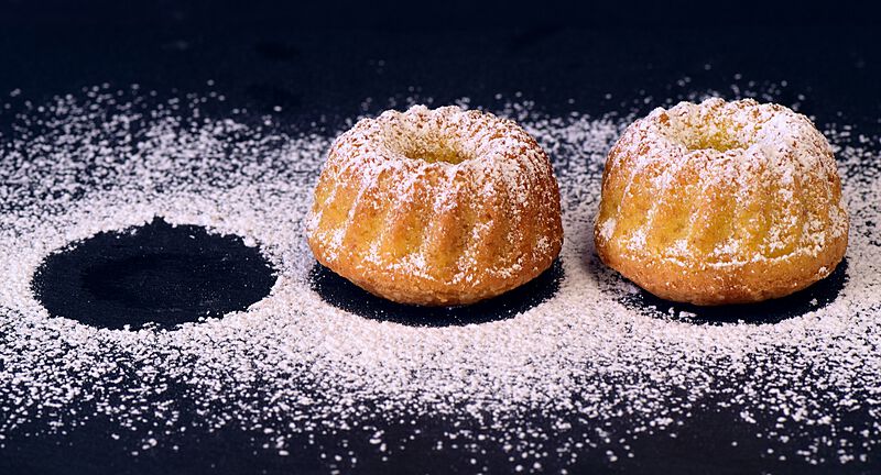 two-round-kouglof-cakes-splashed-with-sugar-laid-on-a-table